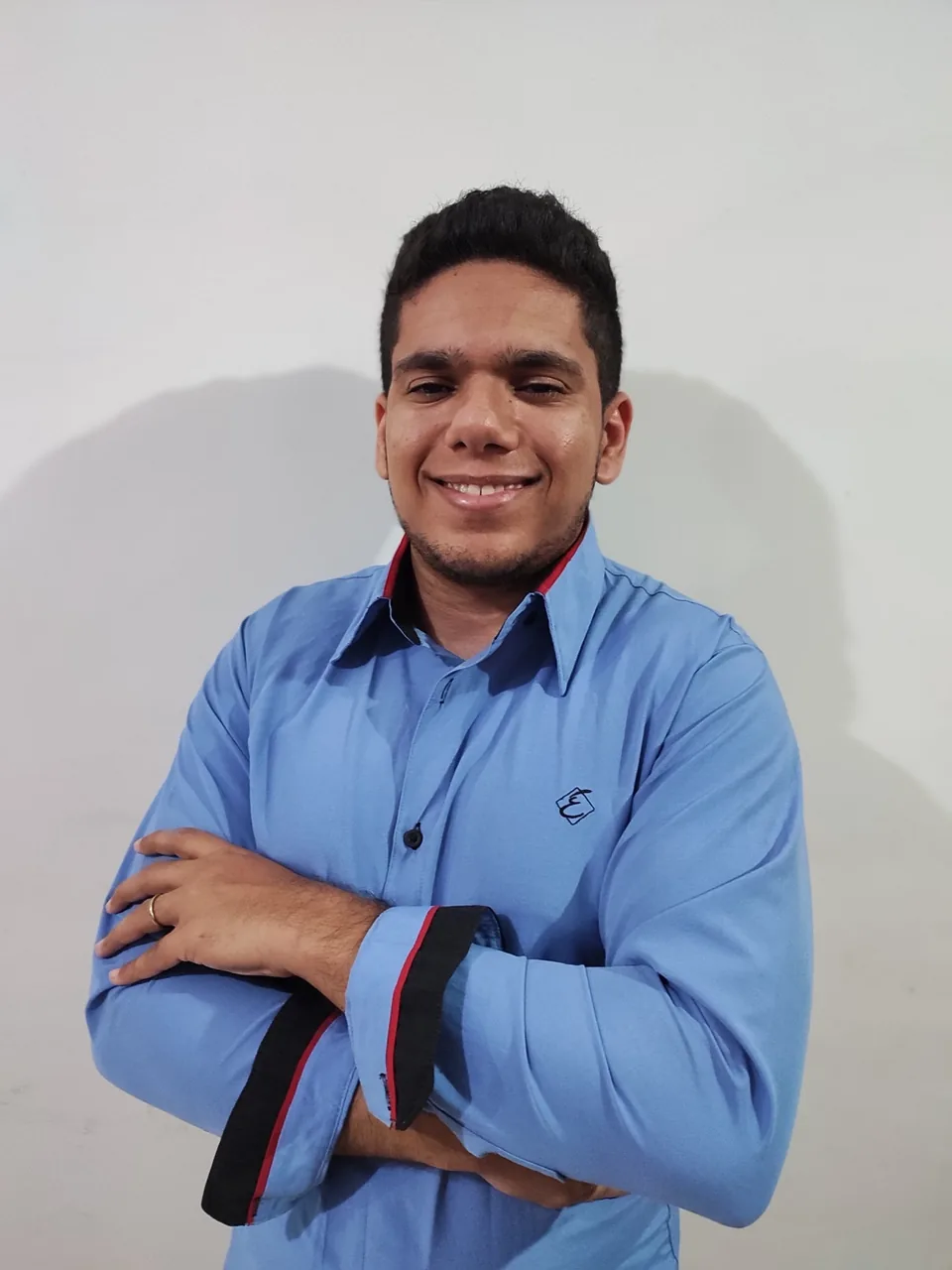 Rick Oliveira smiling in a blue shirt